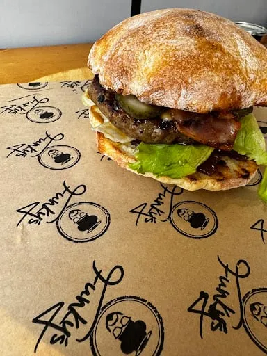 Funky's burger with a beef patty, cheese and fresh vegetables